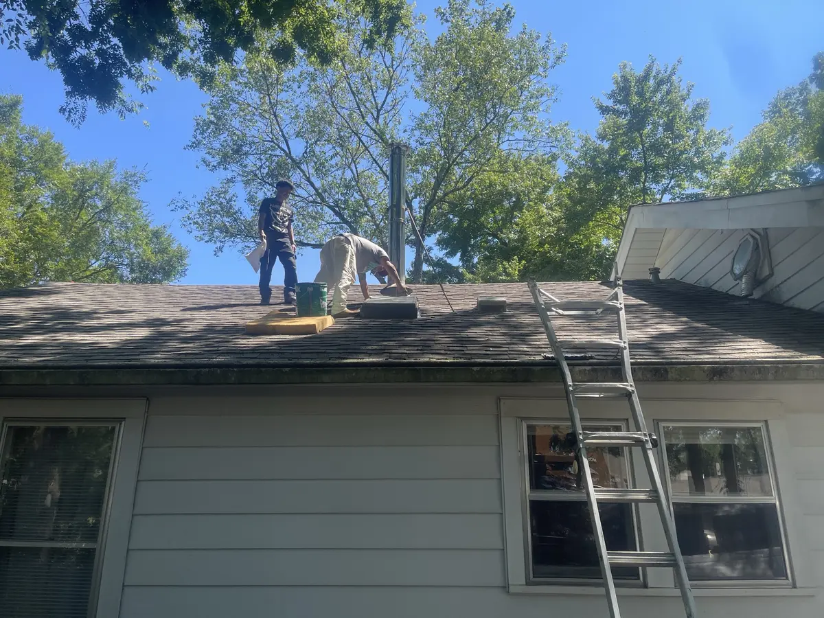 Hero Roofing crew members working on the roof of a home in Central Arkansas