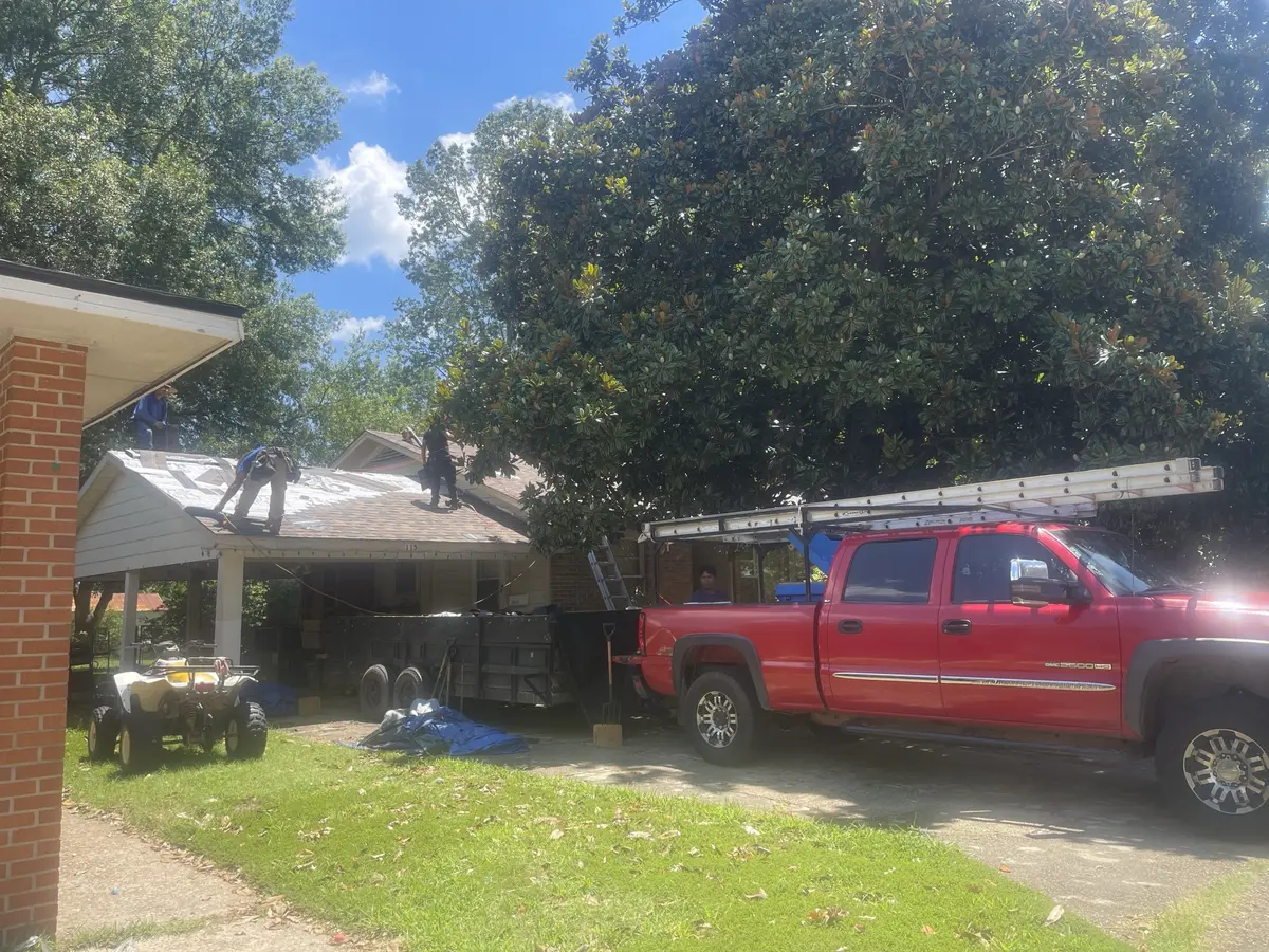 Hero Roofing crew and equipment on site during a roof replacement on a brick home in Central Arkansas