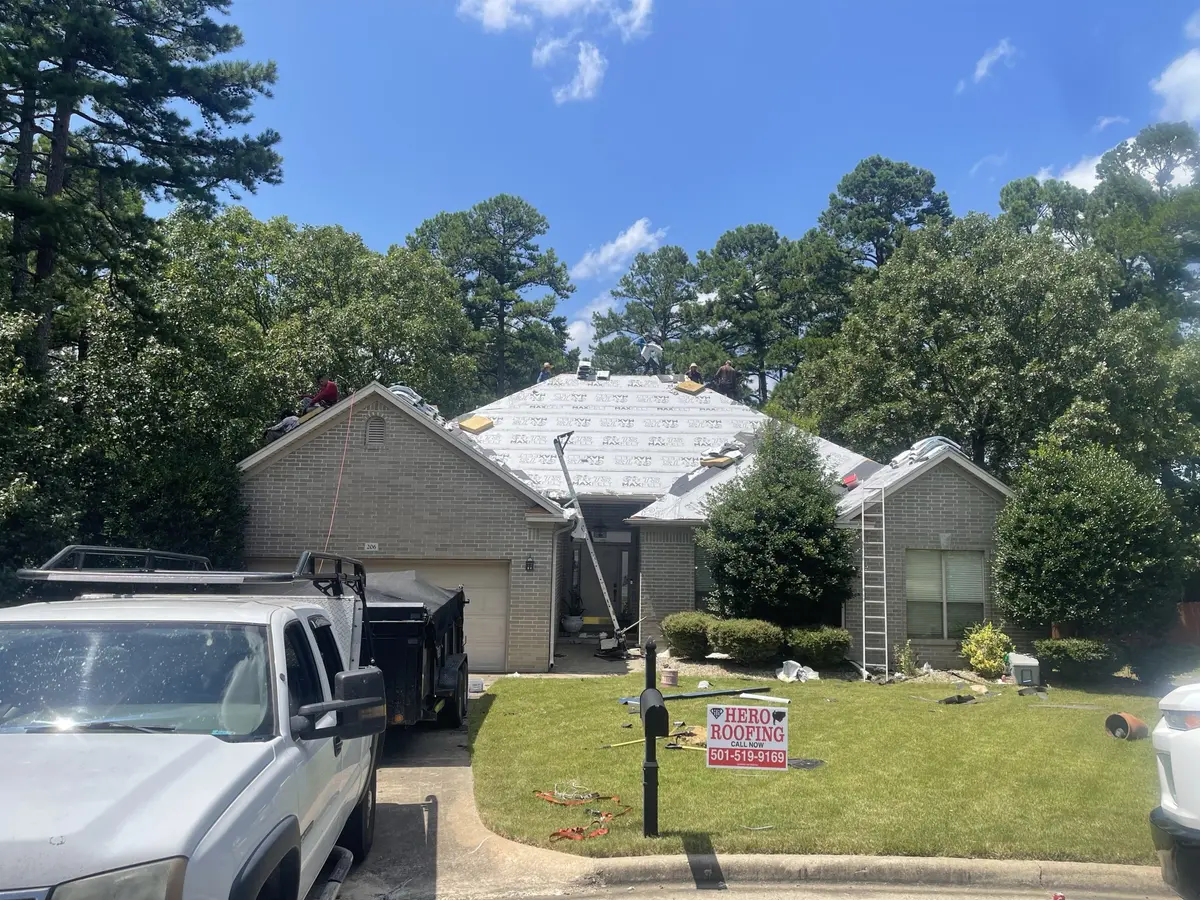 Hero Roofing crew on the roof with underlayment laid down during a roof replacement on a brick home in Central Arkansas