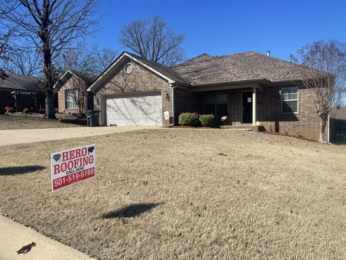 Completed asphalt shingle roof on a brick home in Central Arkansas with a Hero Roofing yard sign out front