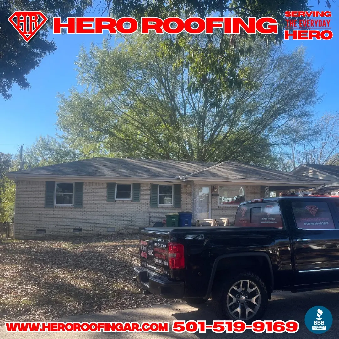 Completed roof replacement on a light brick ranch home in Central Arkansas with the Hero Roofing truck parked out front