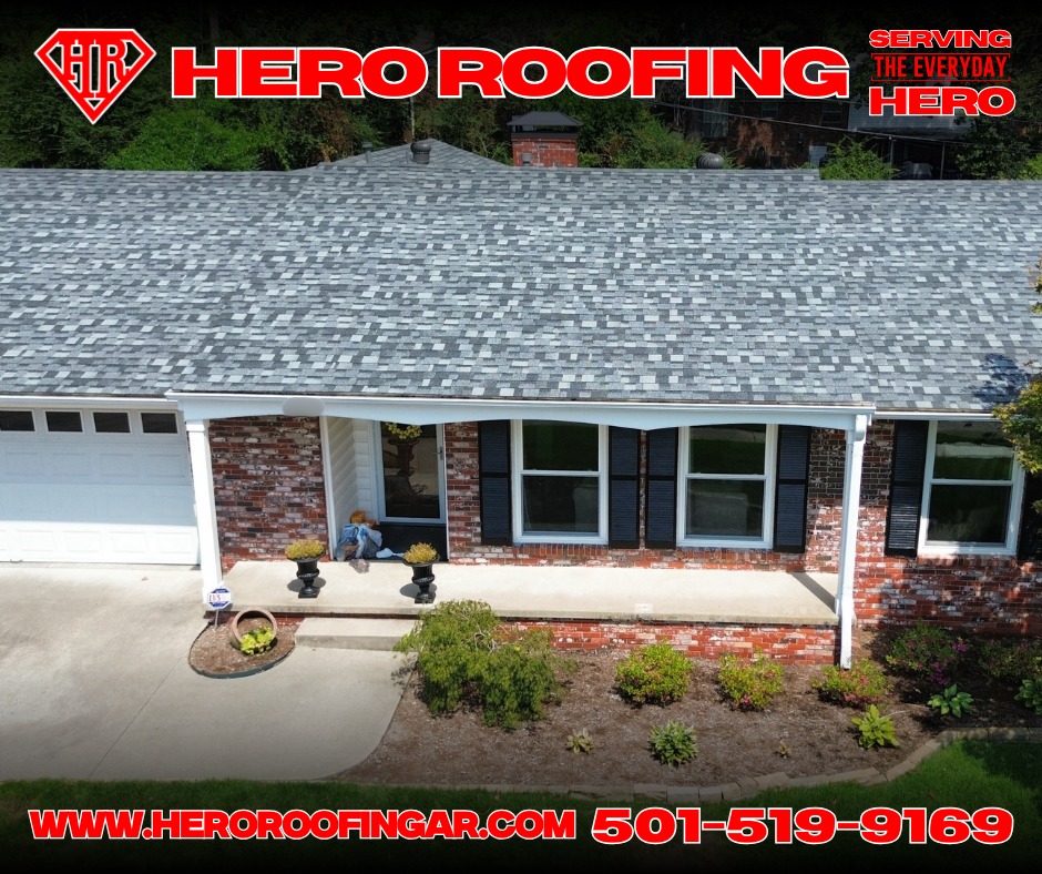 Elevated view of a completed asphalt shingle roof on a brick home with black shutters in Central Arkansas by Hero Roofing