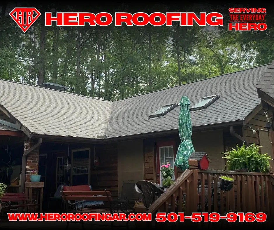 Completed asphalt shingle roof with skylights on a wood-sided home set in the trees in Central Arkansas by Hero Roofing