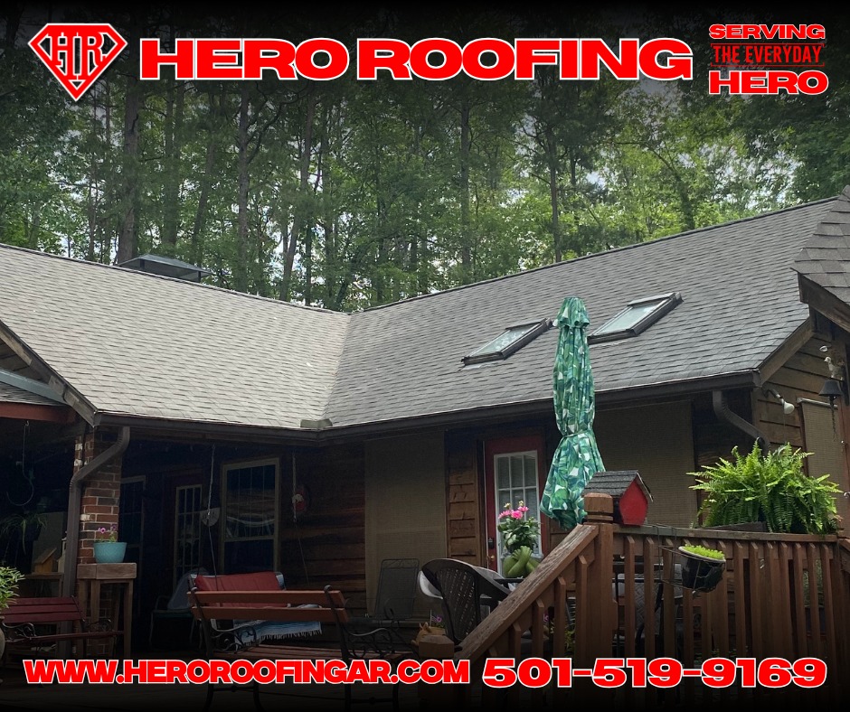 Completed asphalt shingle roof with skylights on a wood-sided home set in the trees in Central Arkansas by Hero Roofing
