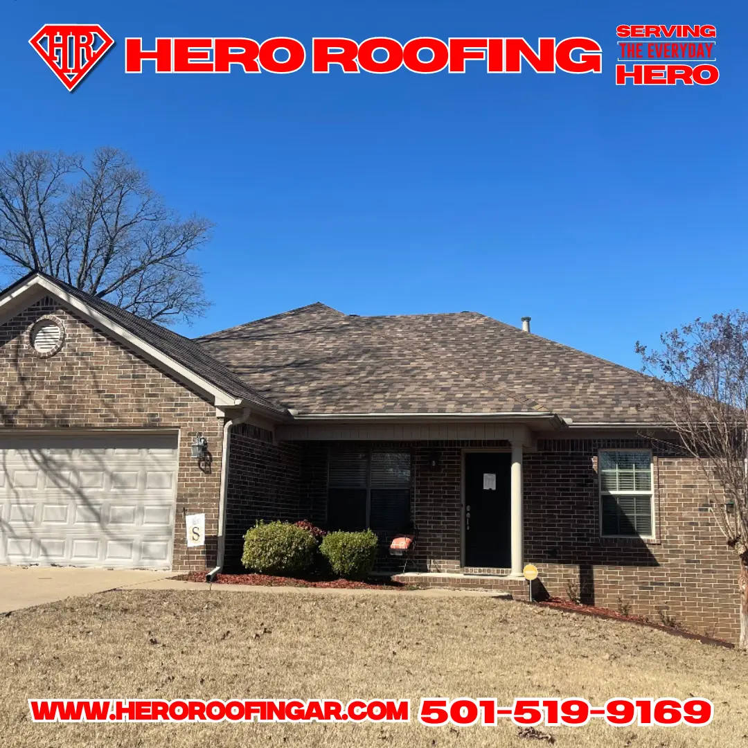 Completed asphalt shingle roof on a brick home under a clear blue sky in Central Arkansas by Hero Roofing